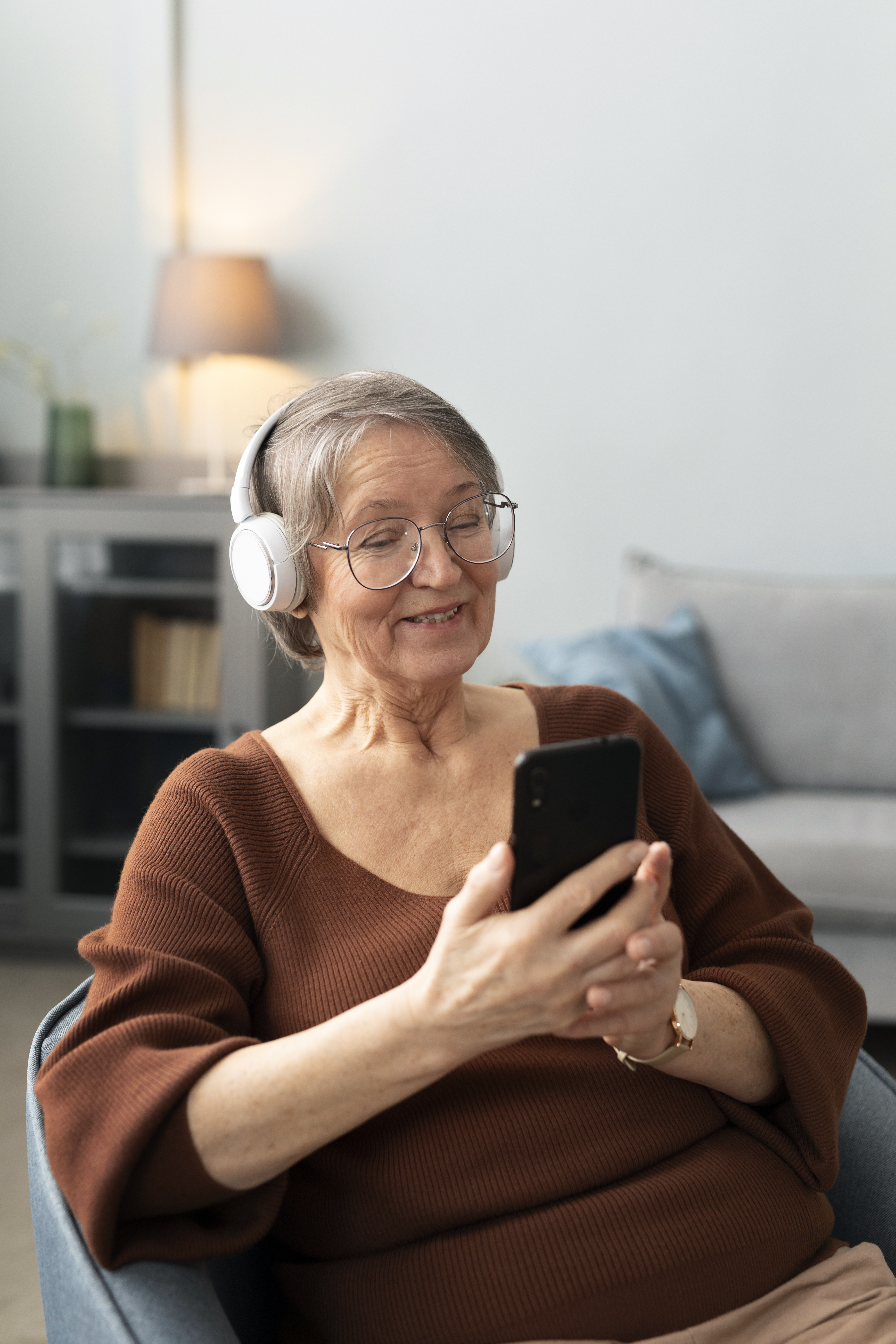 Elderly woman smiling while talking on phone at home